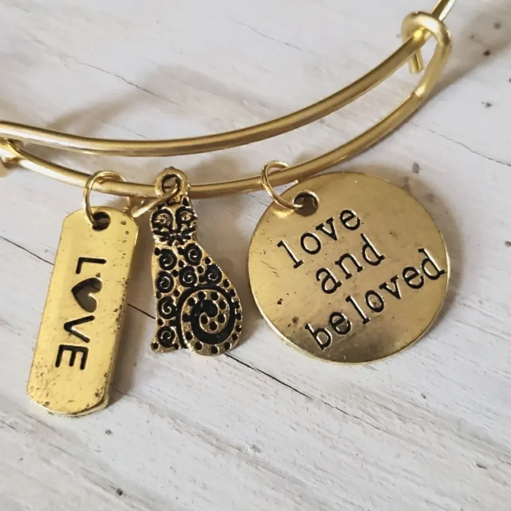 Bracelets by Sandra gold tone adjustable, Love